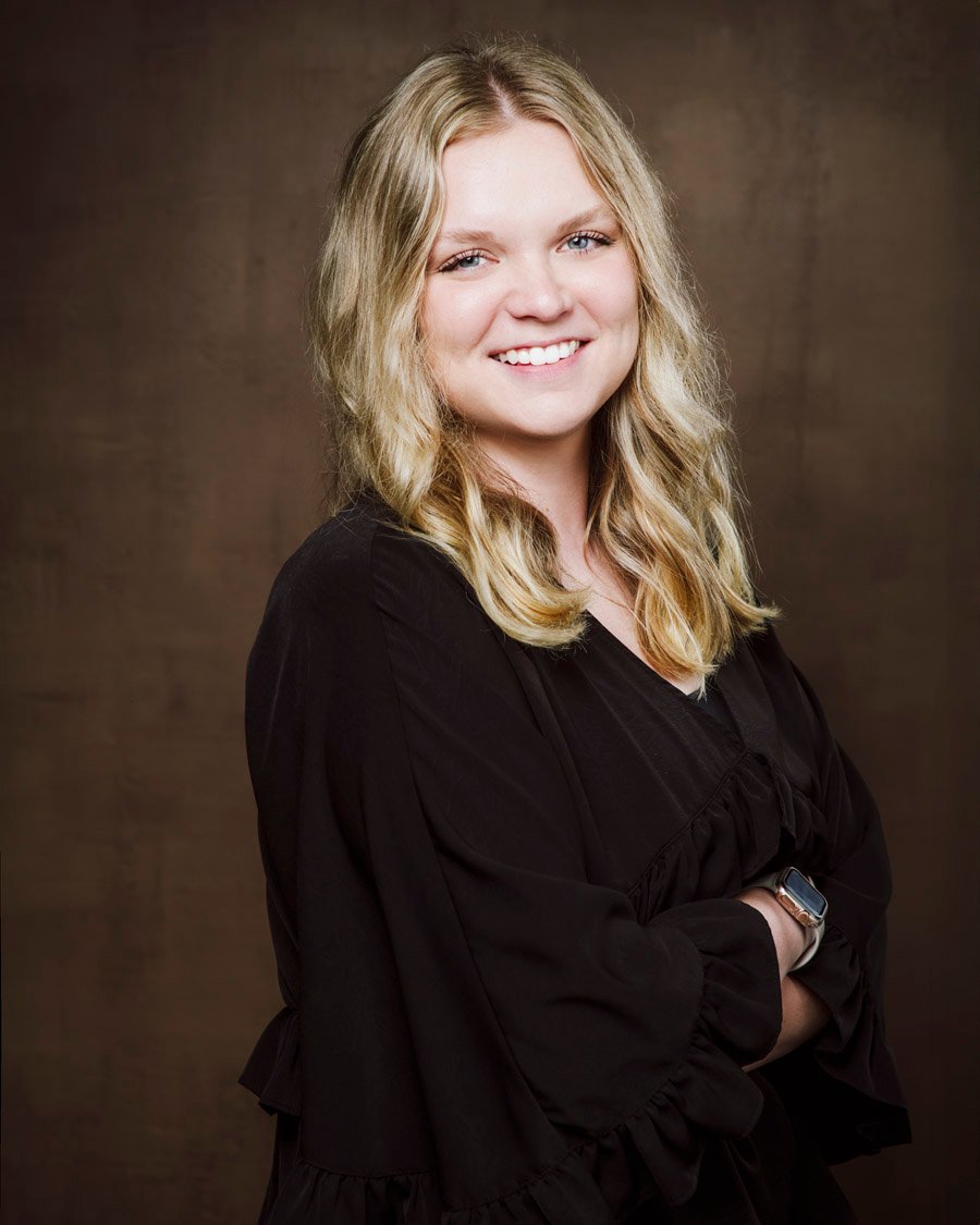 Low Key headshot of blonde female wearing black shirt