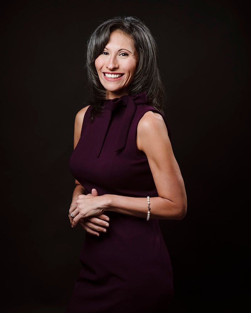 Dark background female professional headshot