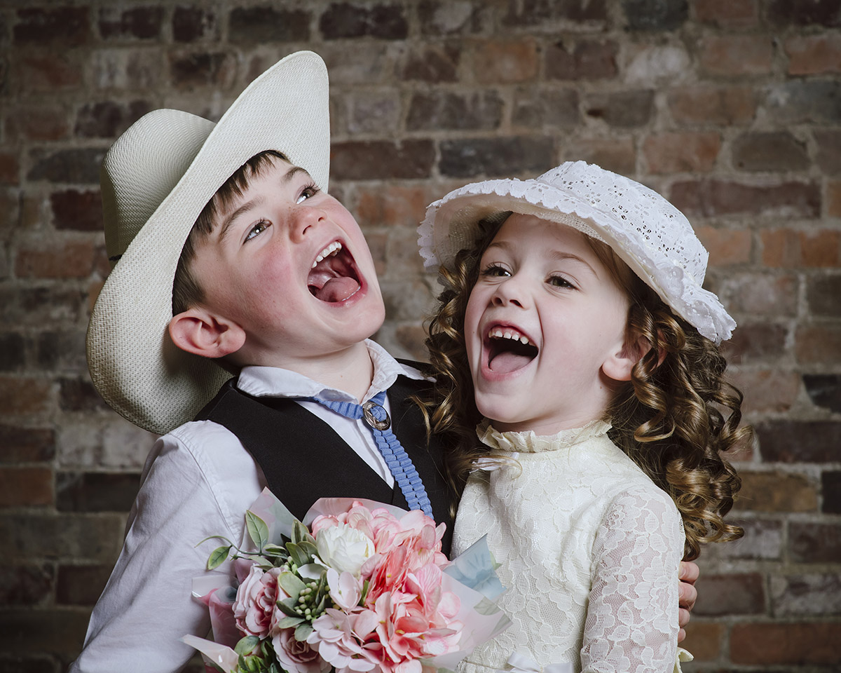 cousins laughing during a vintage studio photoshoot